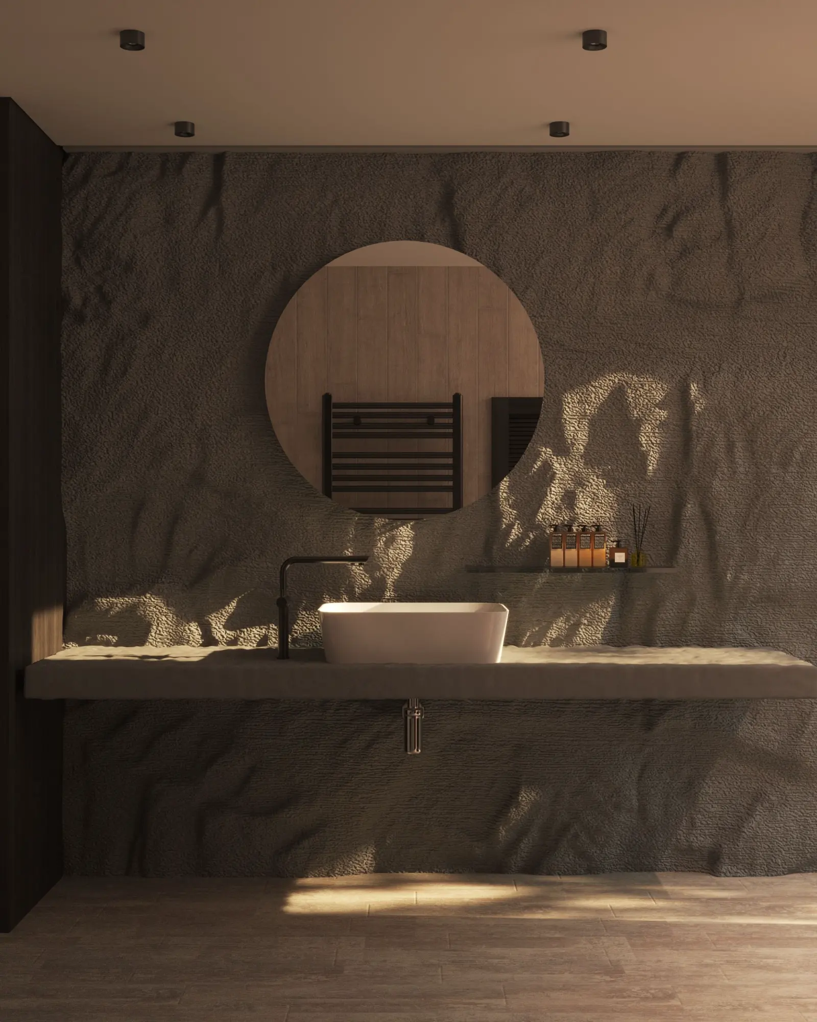 Bathroom at Granite House: a textured stone wall and a cast basin on a rough concrete shelf, low sun raking across the render.